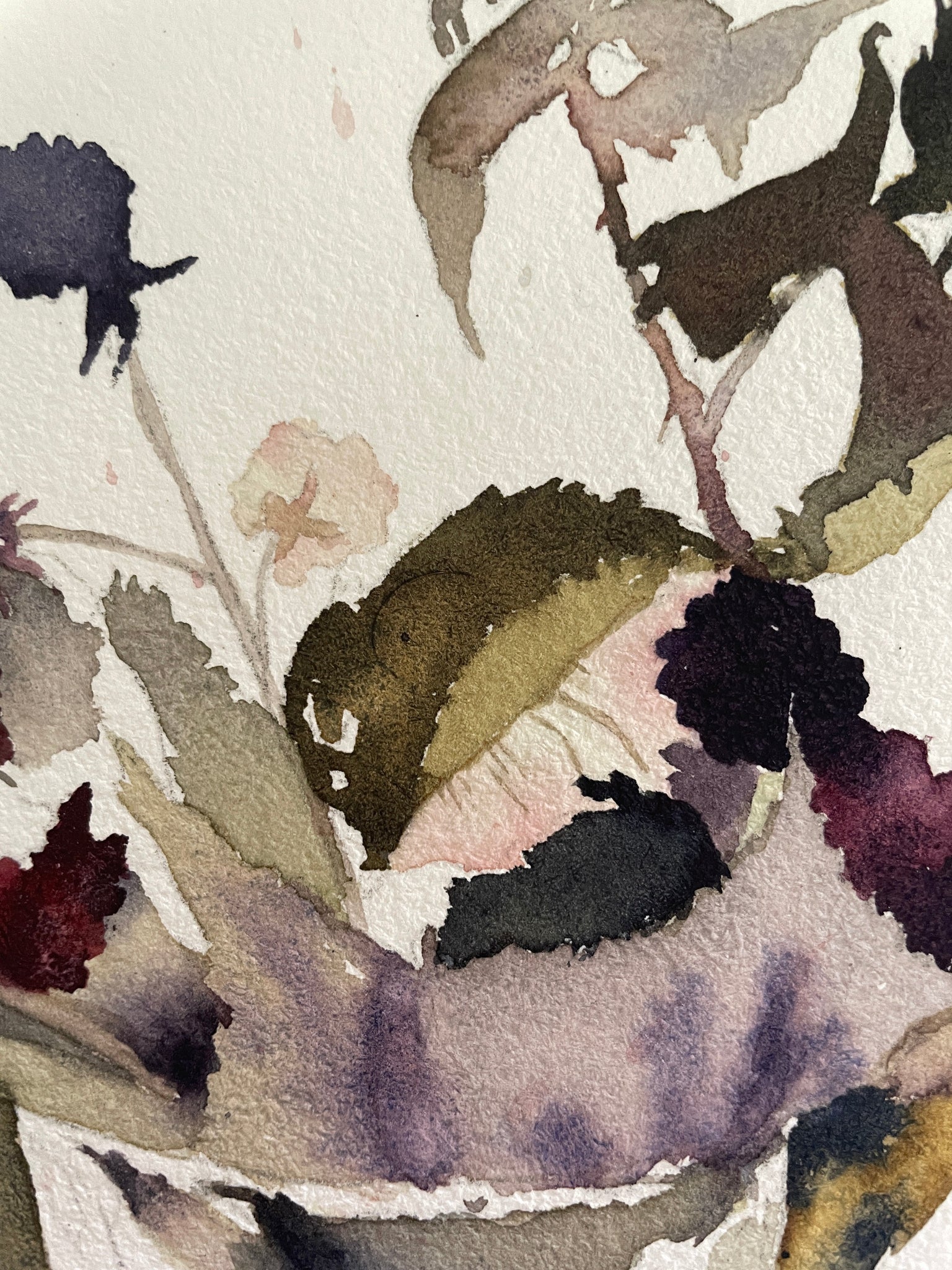 Close-up of watercolor painting with leaves and flowers on a light background