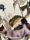 Close-up of watercolor painting with leaves and flowers on a light background